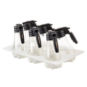 Four clear polycarbonate dispensers with black trigger handles are placed upright in a white rectangular holder, each in its own compartment. The bottles are dishwasher safe and empty, with labeled handles. The background is plain white.
