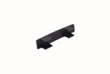 A small, black, rectangular polypropylene component with two tabs extending from the bottom. The surface appears slightly textured and indented text is visible on the top side. The object is photographed on a plain white background.