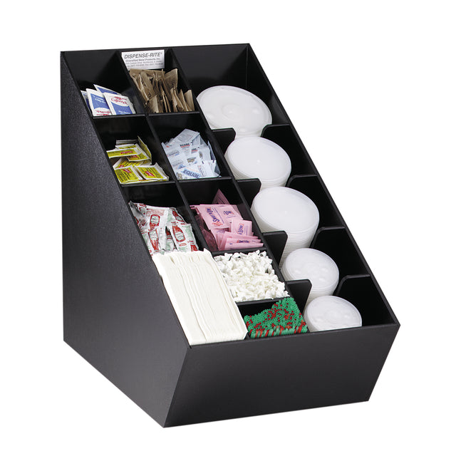 A black, angled condiment organizer neatly holds beverage supplies: stacked plastic lids, paper cups, stir sticks, a straw organizer, packets of sweetener, sugar, creamer, salt, pepper, ketchup, and napkins in separate compartments.