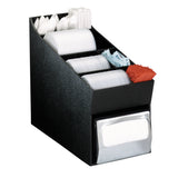 A black countertop condiment organizer holds white plastic forks, knives, spoons, stacked paper plates, wrapped straws, sugar packets, red napkins, and features a metal napkin organizer dispenser at the bottom front.