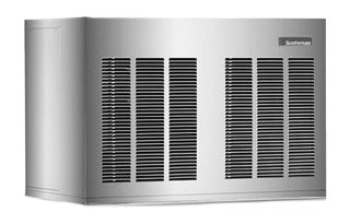 A large, rectangular, silver Scotsman outdoor generator with black ventilation grilles on the front and side panels. The smooth surface features a small brand label on the top right corner. The generator sits on a flat surface, viewed at an angle.