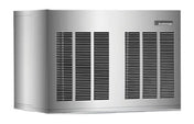 A large, rectangular, silver Scotsman outdoor generator with black ventilation grilles on the front and side panels. The smooth surface features a small brand label on the top right corner. The generator sits on a flat surface, viewed at an angle.