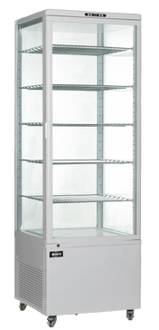 A tall, silver Omcan USA refrigerated display case with a 500 liter capacity features five wire shelves, clear glass sides and front door, a left-side handle, vented bottom section, and small wheels. The fridge is empty and set against a plain background.