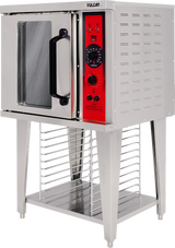 A stainless steel Vulcan half-size electric convection oven stands on four legs with a storage rack below. The oven door has a large black handle, and the red control panel features black dials and buttons for temperature, timer, and settings.