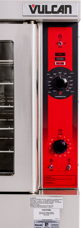 Close-up of a Vulcan single-deck commercial convection oven control panel with a red face. Two black knobs for temperature and timer settings, plus several buttons and indicator lights, are visible. Oven racks are partially seen on the left behind a glass door.