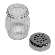 A clear, BPA free shaker jar with a wide mouth and decorative vertical grooves sits beside its detached round metal lid, which features multiple evenly spaced holes for dispensing contents. The jar and lid rest on a plain white background.