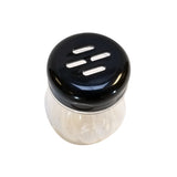 A clear, BPA free glass shaker with a black plastic lid featuring three large horizontal slots. The dishwasher safe shaker is mostly empty and sits against a plain white background.