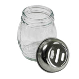 A clear, BPA Free glass shaker jar with a stainless steel lid placed beside it. The lid has three rectangular holes for dispensing grated cheese or spices. The simple jar features gentle curves and is shown against a plain white background.