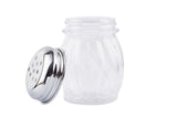 A clear, BPA free glass shaker with a decorative swirl pattern, shown with its round, metal perforated lid removed and resting upright beside it, all set against a plain white background.