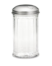 A clear, empty glass sugar dispenser with vertical ribbed sides and a shiny stainless steel lid featuring a small, curved cutout for pouring. The pourer is set against a plain white background.