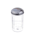 A clear, empty, ribbed glass sugar dispenser with a shiny stainless steel lid featuring a small pourer slot for easy dispensing, shown against a white background.