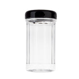 A clear, empty polycarbonate glass jar with vertical ridges and a black, glossy screw-on lid is centered against a plain white background. This cylindrical, dishwasher safe jar is clean and ideal for storing food or spices.