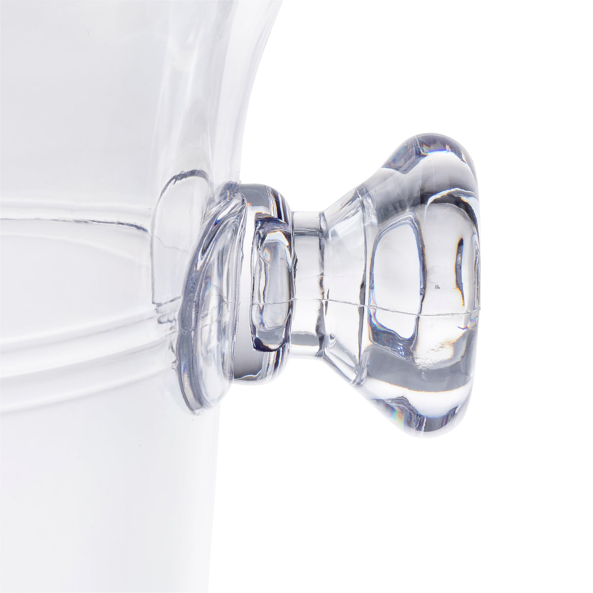 Close-up of a transparent handle on the side of a clear 1.5 qt TableCraft PB5115 Wine Bucket, photographed against a plain white background. The rounded handle features smooth contours and visible reflections.