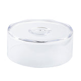 A clear, round plastic TableCraft cake cover with a flat base and matching transparent lid. The lid features a shallow circular indentation, and the edges of both the base and lid are smooth and slightly wavy. The container is empty.