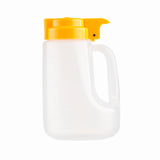 A translucent BPA free plastic pitcher with a side handle and bright yellow flip-top lid, shown against a white background. The 32 oz dispenser has measurement markings on the side, and the lid features a spout for easy pouring.