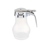 A clear glass syrup dispenser with a shiny metal lid and handle, featuring a lever for easy pouring. The teardrop design adds elegance, and the dispenser is dishwasher safe. Set against a plain white background.