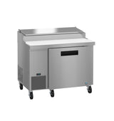 A commercial Hoshizaki stainless steel pizza prep table with a refrigerated base, cutting board surface, and lid. Features one door, a digital temperature display, and four black caster wheels for mobility; ideal for restaurant kitchens.