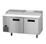 The Hoshizaki Steelheart Series pizza prep table features two doors, a digital temperature display on the left, dual top lids, four caster wheels, and a white cutting board running along the front beneath the compartment lids.