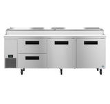 A large stainless steel pizza prep table features two refrigerated drawers on the left, two swing doors on the right, a digital control panel, bottom-left ventilation, four caster wheels, and an integrated prep station on top.