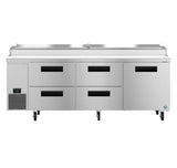 A large Hoshizaki Steelheart pizza prep table with a flat stainless steel top, six black-handled drawers, and wheels for mobility. The left side features a digital temperature display panel and vent, plus a raised section for ingredient storage.