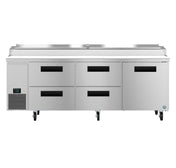 A large Hoshizaki Steelheart pizza prep table with a flat stainless steel top, six black-handled drawers, and wheels for mobility. The left side features a digital temperature display panel and vent, plus a raised section for ingredient storage.