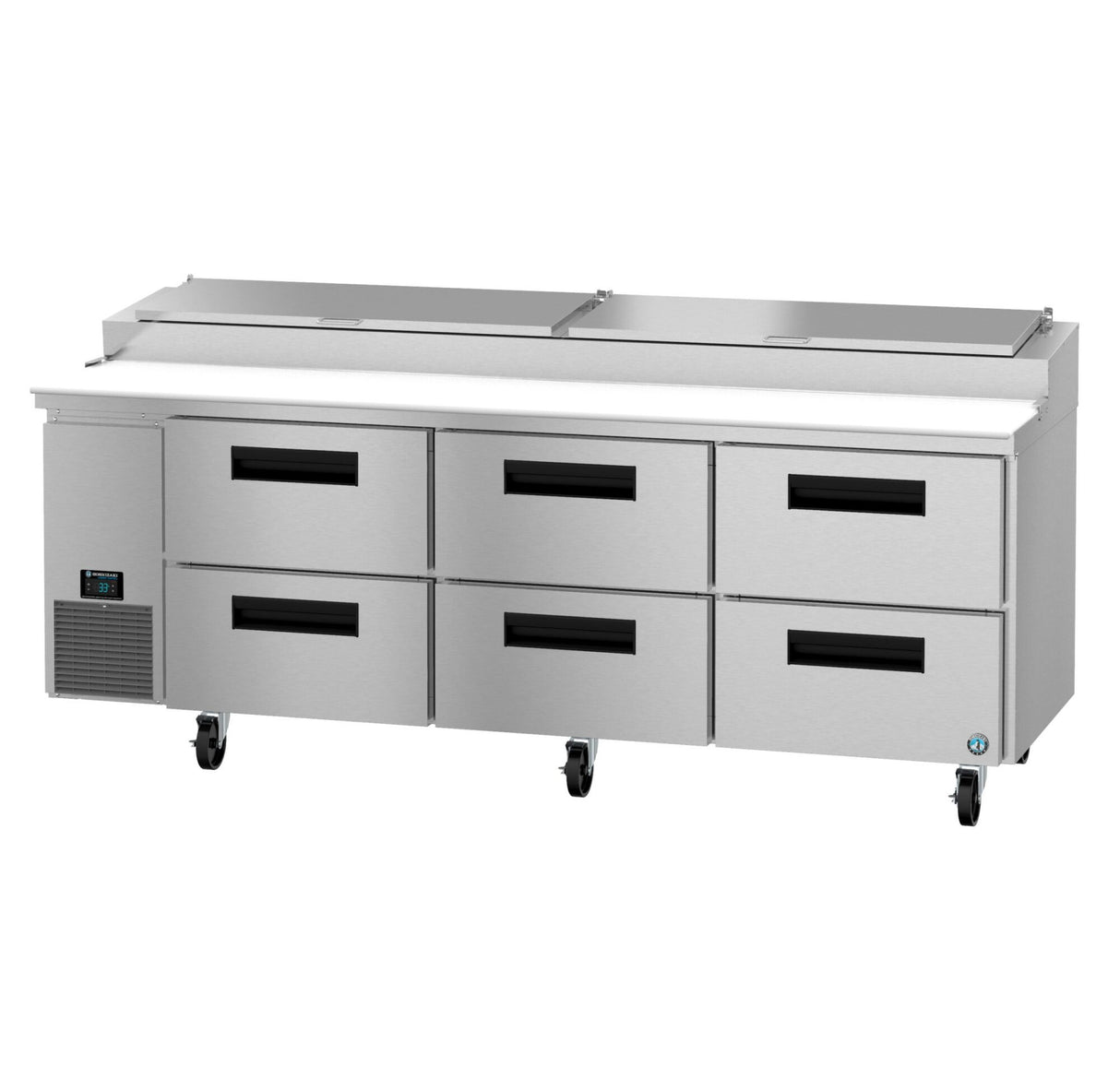 A large stainless steel pizza prep table with six black-handled refrigerated drawers, a flat white prep surface on top, and a digital control panel on the left; unit is on wheels and features three covered compartments along the back.