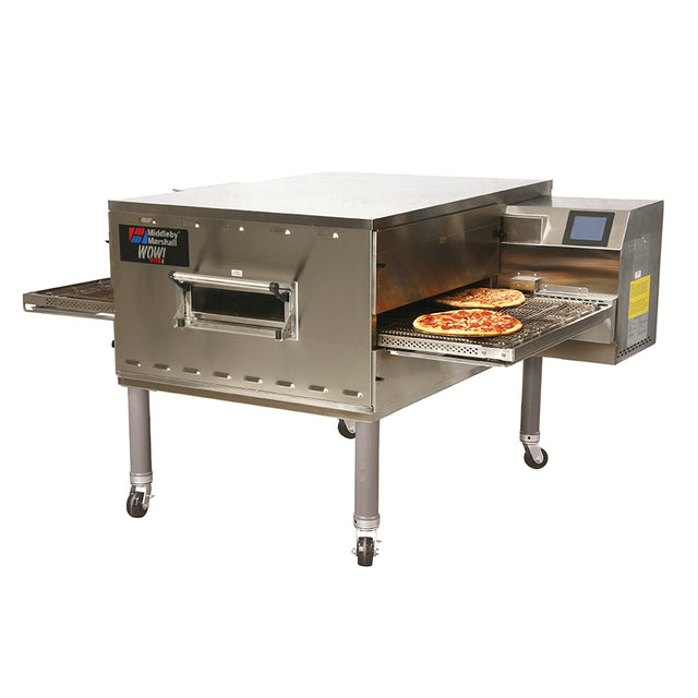 A large stainless steel Impingement PLUS Conveyor Oven on wheels, with two pizzas visible on a conveyor belt partially emerging from the oven. The oven has control buttons, a digital display, and ventilation openings on the side.