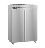 A large, stainless steel Steelheart Series Refrigerator with double doors, vertical handles, a digital display, top ventilation grille, and four caster wheels. Its clean surface reflects light, making this pass-thru refrigerator ideal for any commercial kitchen.
