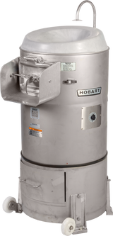 A large, industrial stainless steel Hobart 6460-1 Potato Peeler stands upright. It features a lidded top with curved handle, side door, control panel, and wheels for mobility. Various warning and instruction labels are visible on the body.