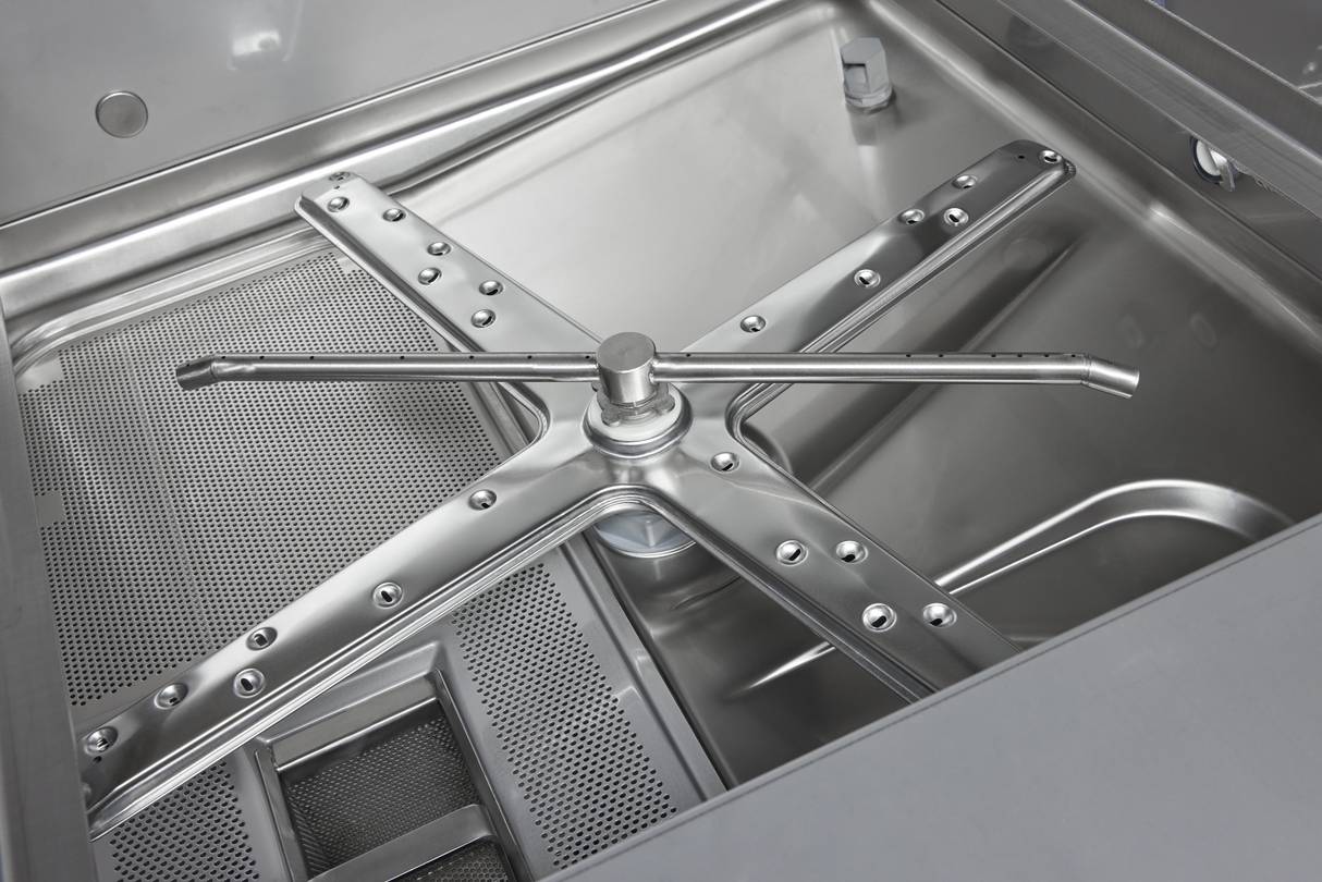 Close-up view of the interior of a Hobart Advansys ventless pot pan washer, showing a large stainless steel spray arm with multiple nozzles above a perforated metal filter tray. The clean, reflective surfaces highlight the machine’s sturdy construction.