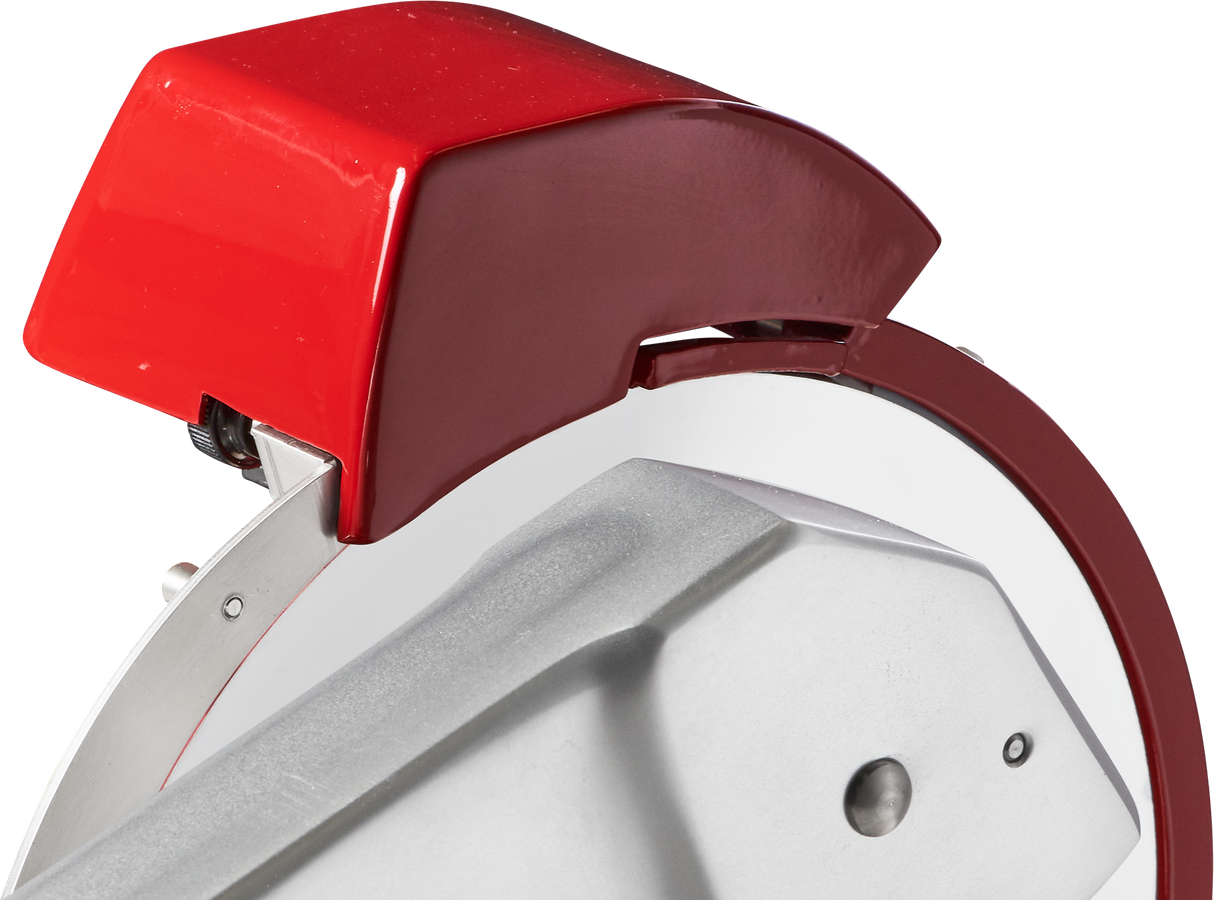 Close-up of a Berkel Fly Wheel Slicer featuring a shiny, chromium-plated carbon steel knife partially covered by a red protective guard. The slicer has a silver-gray angled handle in the foreground, with clean edges and a small screw visible.