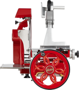 A shiny, red and silver vintage Berkel Fly Wheel Slicer is shown in side profile, featuring a chromium-plated carbon steel knife, intricate details, and a large decorative wheel. The design exudes a classic, retro look.