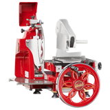 A vintage-style, red and silver Fly Wheel Slicer with a large hand-crank wheel labeled Berkel. It features a shiny chromium-plated carbon steel knife, black tray, and a classic retro industrial design with metal and plastic parts.