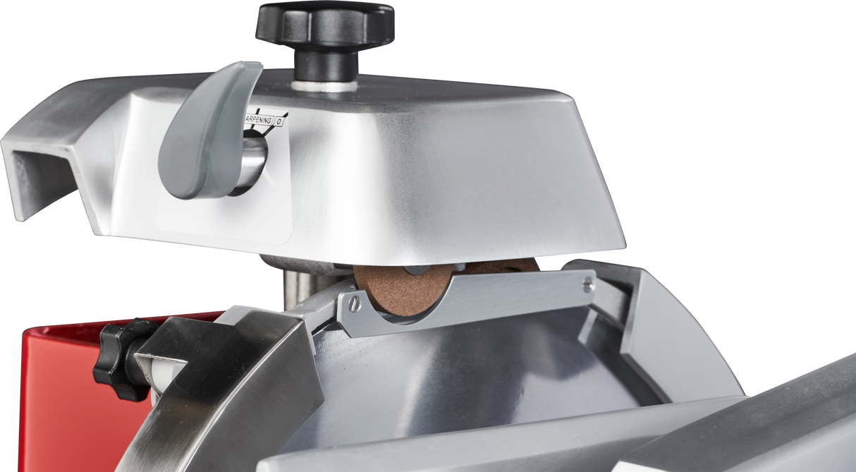 Close-up of a Berkel Fly Wheel Slicer, highlighting the chromium-plated carbon steel knife, metal blade guard, brown sharpening stone, adjustment knob, and part of the shiny, curved slicer blade against a black background.