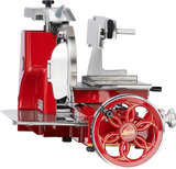 A vintage Berkel 330M Fly Wheel Slicer with a large hand-crank wheel, chromium-plated carbon steel knife, and metal platform for holding food, featuring ornate detailing and a Berkel logo at the center of the wheel.