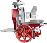 A vintage-style Berkel 330M Fly Wheel Slicer in red and silver, featuring a chromium-plated carbon steel knife, a large decorative wheel with gold script, an adjustable white platform, and a flat metal base.