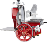 A red and silver vintage-style Fly Wheel Slicer features ornate metalwork, a large hand-crank wheel with floral spokes, a chromium-plated carbon steel knife, a platform for food, and adjustment knobs, all against a white background.