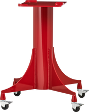 A bright red Berkel slicer stand with casters features a sturdy central column and four wide, flared legs, each ending in a swivel caster wheel. The flat platform on top is ideal for supporting equipment or tools, giving it an industrial and mobile design.