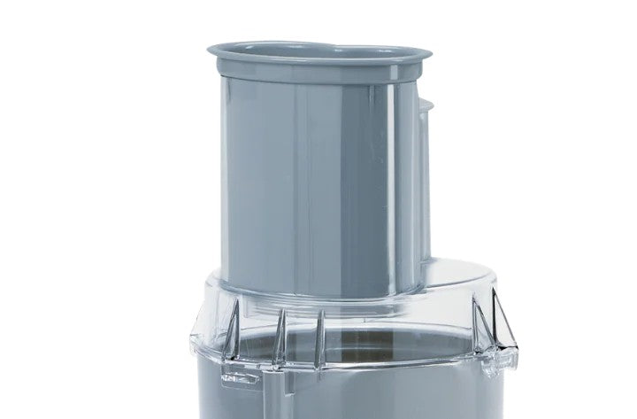 A close-up of a Robot Coupe R101P Combination Food Processor part, featuring a cylindrical chute for the vegetable prep function on a transparent lid with locking tabs. The background is plain white.