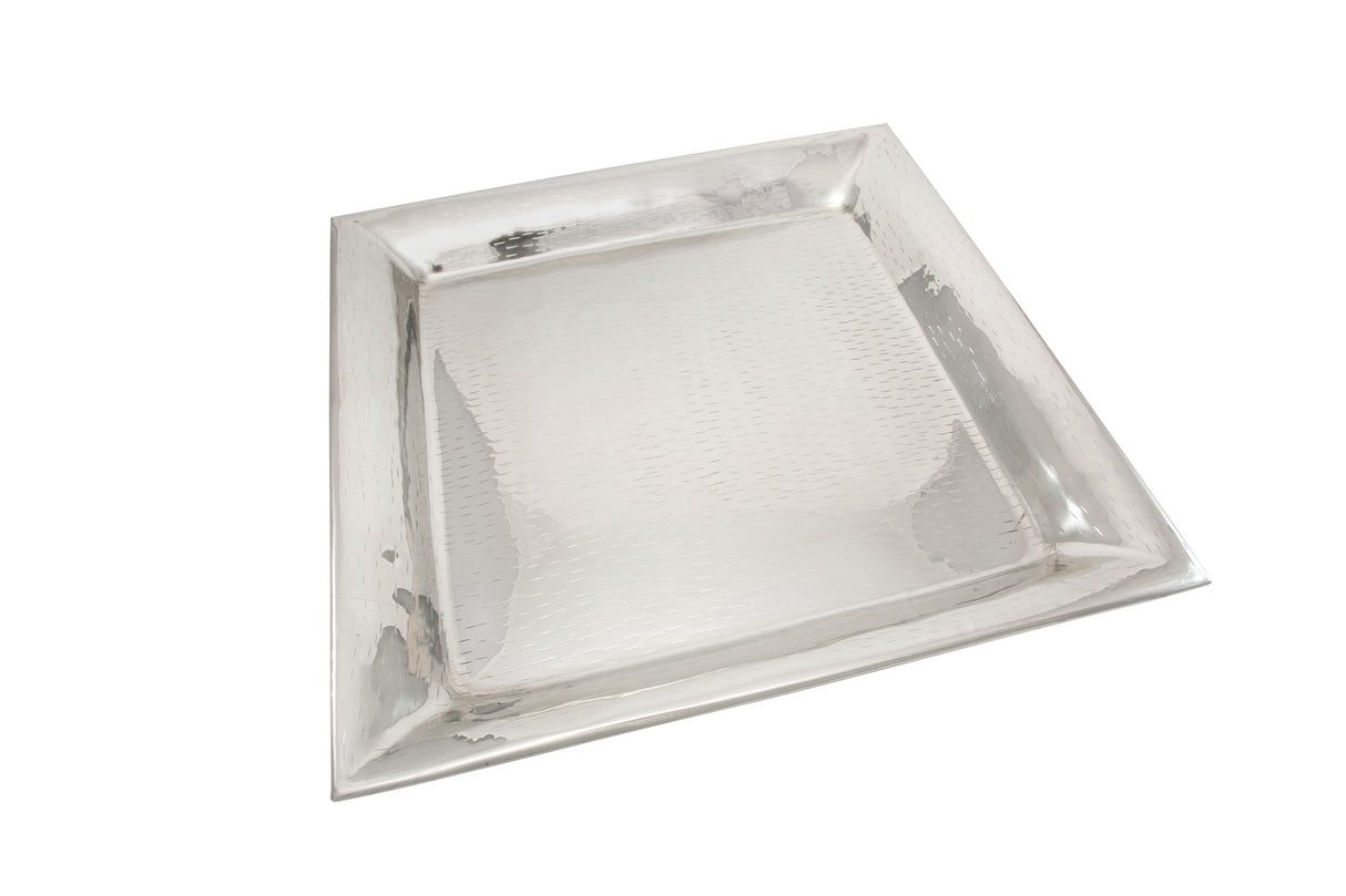A rectangular Remington Collection tray with slightly raised, sloped edges and a textured, hammered surface. This stainless steel tray features a shiny, reflective finish and is photographed on a plain white background.