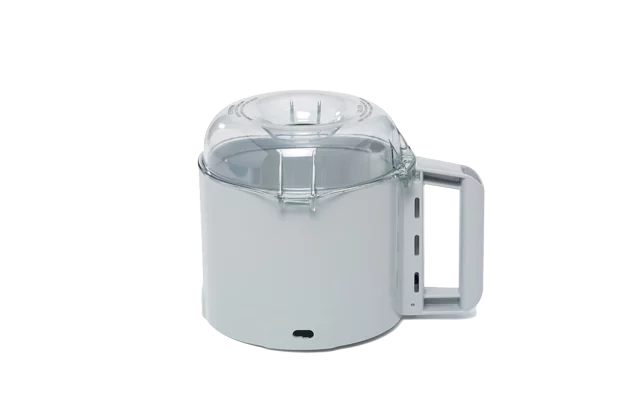 A compact electric appliance, the Robot Coupe R301 Dice Combination Food Processor features a cylindrical white base, a large right-side handle, and a clear dome-shaped lid with latch—ideal for use with a dicing kit. Photographed against a plain white background.