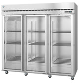 A large Steelheart Series Refrigerator with three glass doors showcases multiple wire shelves inside. This reach-in refrigerator stands on wheels for mobility and features a digital temperature display on the top right corner.