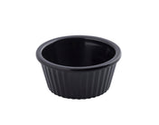 A small, round, black ceramic ramekin with fluted sides and a smooth rim, isolated on a white background. The interior is glossy, and the overall style is simple and functional—perfect for dishwasher safe convenience.