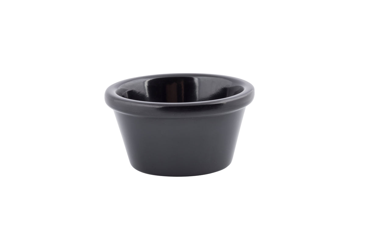 A small, black ramekin with a wide rim and smooth, glossy surface is centered on a white background. This dishwasher safe bowl is empty and simple in design, perfect for serving sauces, dips, or condiments.