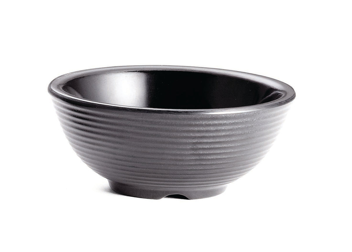 A black ceramic bowl with a glossy interior and matte, ribbed exterior sits on a white background. The simple, round shape resembles a large ramekin and features a small, slightly raised base. This bowl is also dishwasher safe for easy cleaning.