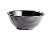A black ceramic bowl with a glossy interior and matte, ribbed exterior sits on a white background. The simple, round shape resembles a large ramekin and features a small, slightly raised base. This bowl is also dishwasher safe for easy cleaning.