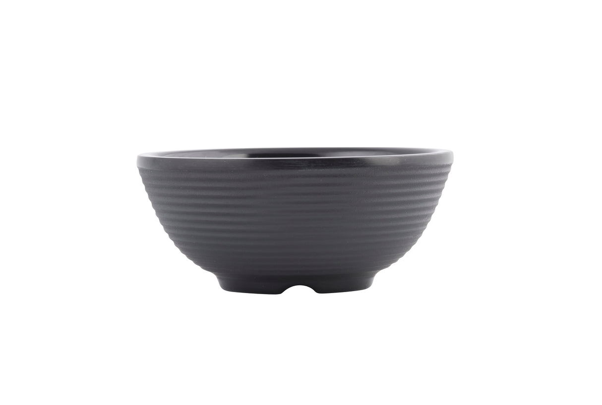 A matte black ceramic bowl with a subtle horizontal ribbed texture, wide rim, and gently curved sides, viewed against a plain white background. This stylish bowl is dishwasher safe and features a small, slightly elevated base.