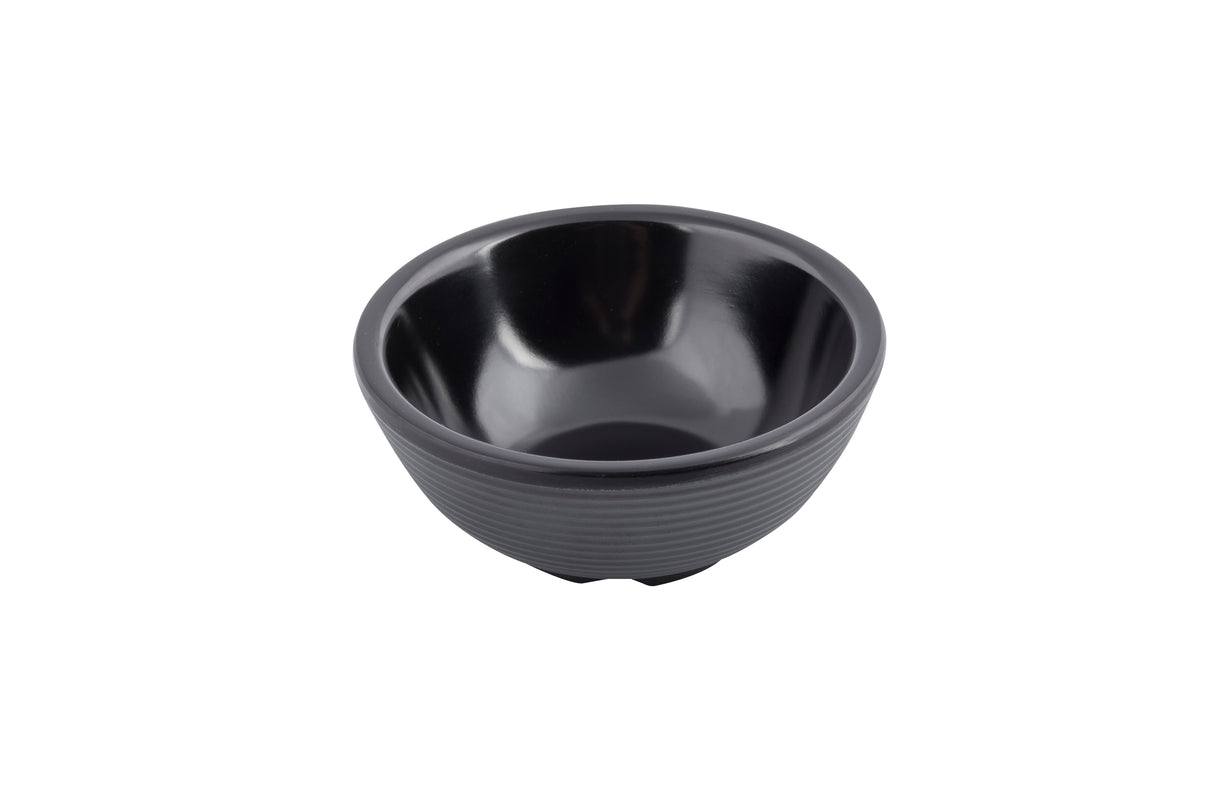 A small, empty, black ceramic ramekin with a glossy finish and horizontal ridges around the exterior sits on a white background.