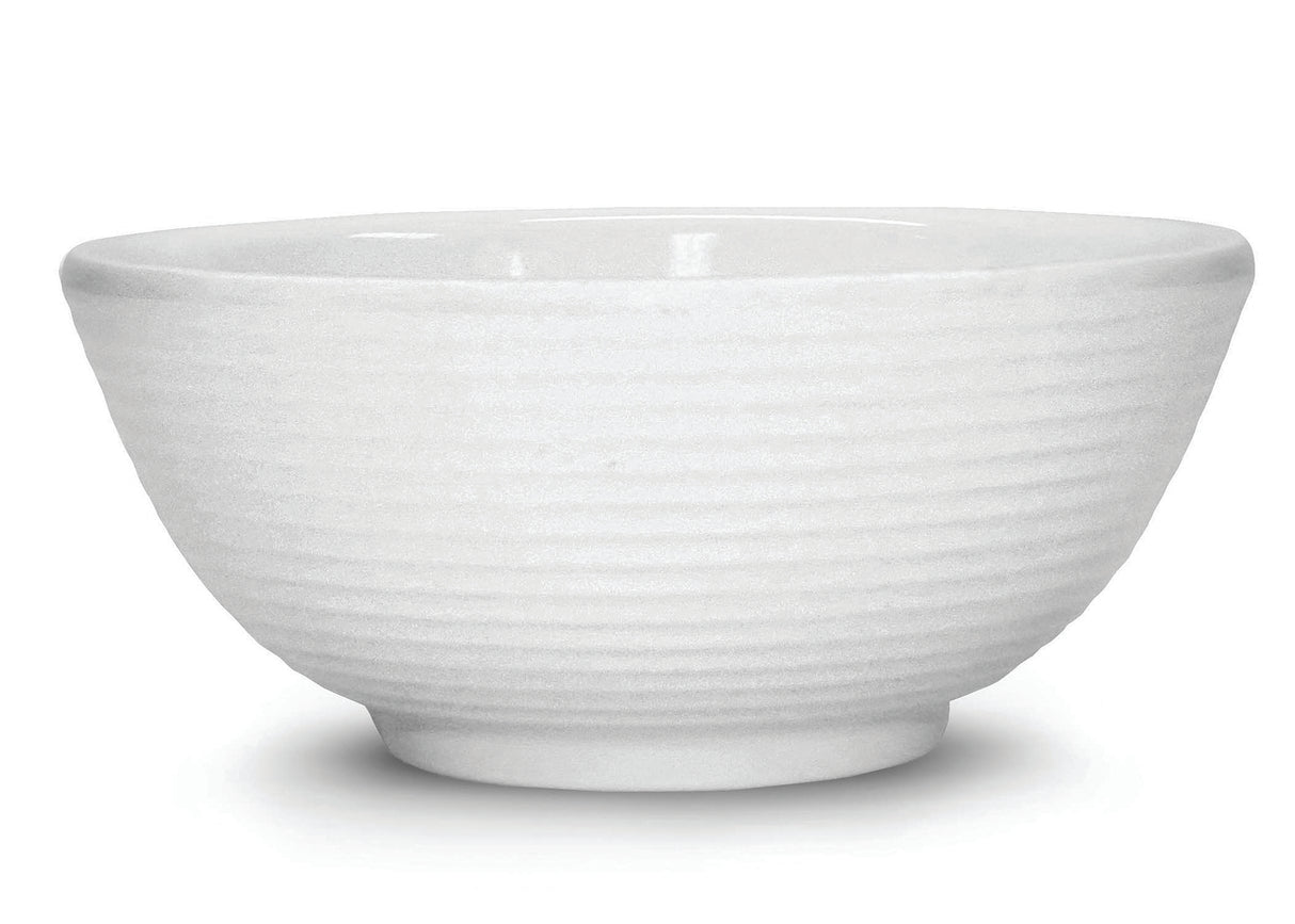 A white ceramic bowl with a subtle horizontal ribbed texture around the exterior. The bowl has a ramekin-inspired, rounded shape, a slightly flared rim, and sits on a small circular base. The background is plain white.