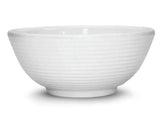 A white ceramic bowl with a subtle horizontal ribbed texture around the exterior. The bowl has a ramekin-inspired, rounded shape, a slightly flared rim, and sits on a small circular base. The background is plain white.